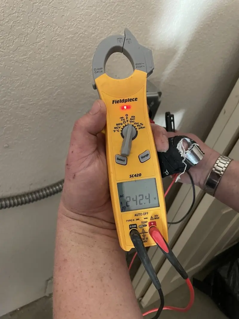 Voltage testing with clamp meter during Electrical Installation Services in DeMotte